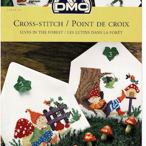 May include: Cross-stitch pattern featuring three elves in a forest setting. The pattern includes a fence, mushrooms, and a bird. The pattern is titled "Elves in the Forest / Les Lutins Dans La Forêt".