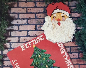 May include: A vintage latch hook pattern book with a red and green Christmas tree rug and a Santa Claus design. The book cover features the title "Latch Hook Patterns "Christmas Cheer"" and the text "Full size patterns for: Santa Rug Christmas Tree Rug and instructions for Santa and Christmas Tree Wall Hanging".