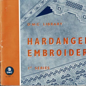 May include: A vintage book cover featuring a blue background with white embroidery designs. The title reads "Hardanger Embroideries 1st Series" and the publisher is "D-M-C Library".