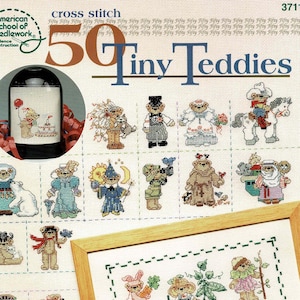 May include: A cross stitch pattern booklet titled 50 Tiny Teddies by Linda Gillum, featuring numerous small, colourful teddy bear designs in various costumes and themes, including a framed example and a circular inset image of a finished project.