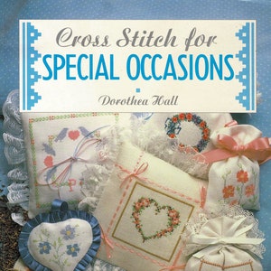 May include: Cross Stitch for Special Occasions by Dorothea Hall, a book showcasing a range of cross stitch patterns for decorative items such as cushions and sachets. The book cover displays a selection of cross stitch projects, including a heart-shaped cushion, a floral wreath, and a lavender sachet.