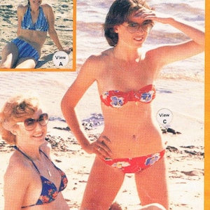 May include: Three women wearing different styles of bikini swimsuits on a beach. The swimsuits are in various colors and patterns. The image includes the text "ladies bikini swimsuits" and "Knitwit".