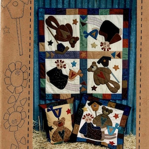 May include: A quilt pattern titled "Dolly & Me" featuring a patchwork design with teddy bears, dolls, stars, and birdhouses. The image includes two pillows with similar designs. The text "The Chook Shed" is at the bottom.