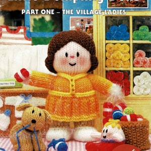 May include: The cover of a vintage knitting pattern book, "Jean Greenhowe's Little Dumpling Dolls." It shows a knitted doll in an orange dress, with other knitted toys like a dog and small figures. The text "Double Knitting Yarn" is displayed.