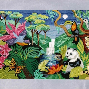 May include: Needlepoint tapestry showing a colourful jungle scene. It features a waterfall, panda, leopard, toucan, parrots, and a butterfly amongst lush foliage. The artwork is rich in colour and detail, showcasing a variety of plants and animals.