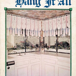 May include: A kitchen with white cabinets and a window overlooking a brick wall with plants. A macrame curtain with pink tassels hangs from the ceiling. The title "Juliano's Hang It All Book 4 Sweet and Sassy" is printed on the page.