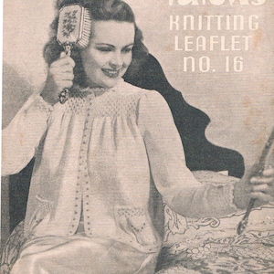 May include: A black and white photo of a woman wearing a white knitted cardigan. She is holding a hairbrush and sitting on a chair. The image is from a vintage knitting pattern leaflet for Patons Knitting Leaflet No. 16, "Margaret" Reprinted by Request 2d.