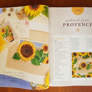 Puede incluir: Una p&aacute;gina de revista que presenta un proyecto de bordado de girasoles. La p&aacute;gina incluye una ilustraci&oacute;n detallada de girasoles, una paleta de colores e instrucciones. El texto "postcard from PROVENCE" es visible.