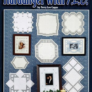 May include: A craft book titled Hardanger with T.L.C. by Terry Lee Capps, compiled by Susan L. Meier and Rosalyn K. Watnemo. The cover displays various white Hardanger embroidery doilies and three framed photographs on a blue patterned background.