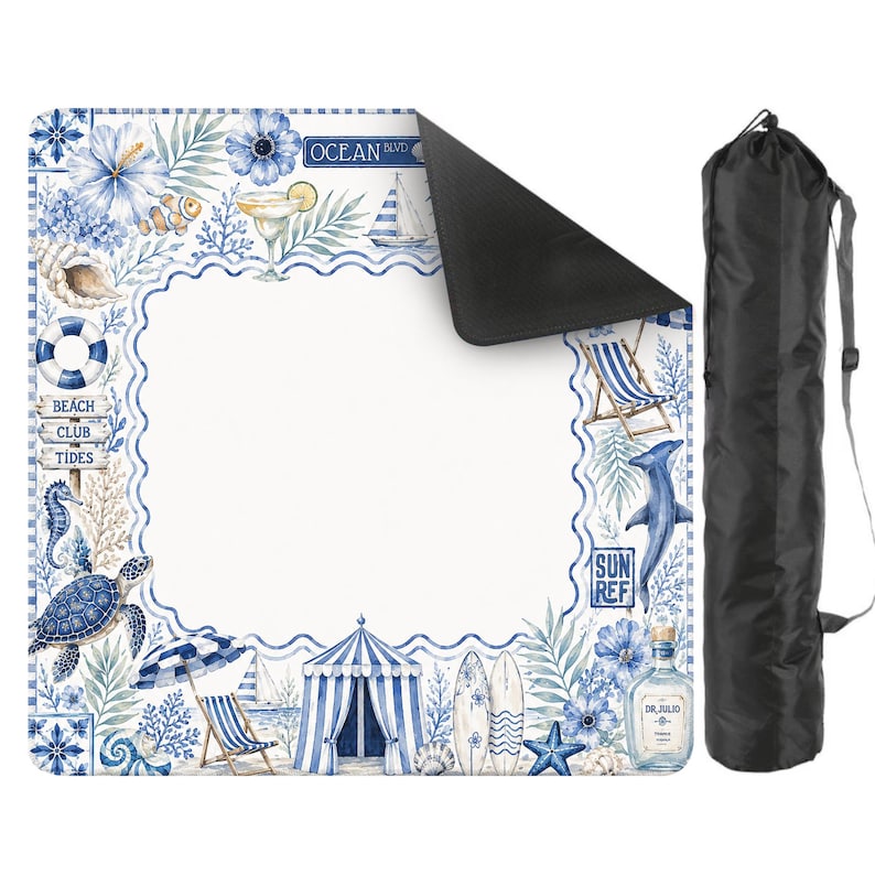 May include: A beach blanket with a coastal design featuring blue and white illustrations of beach scenes, marine life, and the text "Ocean Blvd", "Beach Club Tides", and "Sun Ref". Includes a black carrying bag.