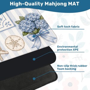 May include: A high-quality Mahjong mat with a floral design featuring blue hydrangeas and a sand dollar. The mat has a soft tech fabric surface and a non-slip thick rubber foam backing. The text "High-Quality Mahjong MAT" is at the top.