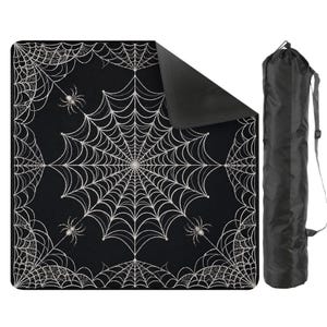 May include: A square black blanket featuring a white spiderweb pattern with small spiders, shown with one corner folded over to reveal a solid black underside. A matching black cylindrical carrying bag with a shoulder strap is positioned to the right.
