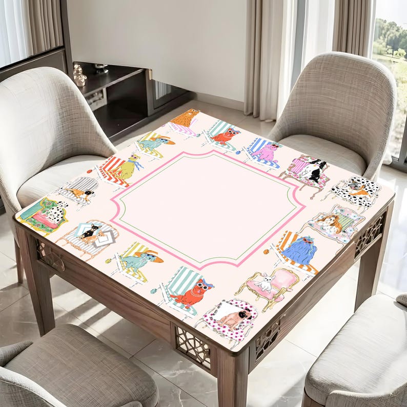 May include: A square wooden table with a light pink surface featuring a border of cartoon dogs in beach chairs. The table has a decorative pink and green border around a central blank space. The table is surrounded by chairs.