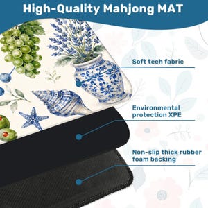 May include: A high-quality Mahjong mat with a decorative design featuring grapes, olives, a seashell, and a blue and white vase. The mat has a soft tech fabric surface and a non-slip thick rubber foam backing.