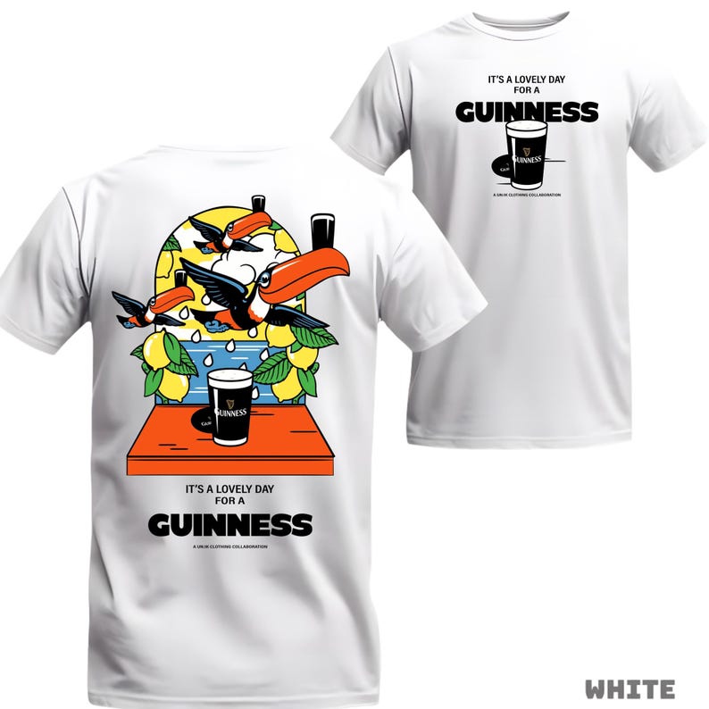 Peut inclure: T-shirt blanc avec un motif Guinness. L'avant pr&eacute;sente un verre de Guinness et du texte. Le dos montre des toucans, des citrons et un verre de Guinness. Le texte se lit "IT'S A LOVELY DAY FOR A GUINNESS".