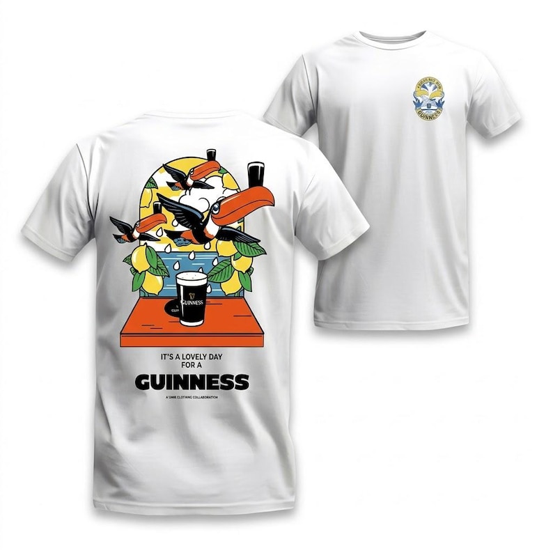 Puede incluir: Camiseta blanca con un gr&aacute;fico colorido de tucanes, limones y una pinta de Guinness. La parte trasera tiene el texto "It's a lovely day for a Guinness". Un dise&ntilde;o m&aacute;s peque&ntilde;o est&aacute; en la parte delantera.