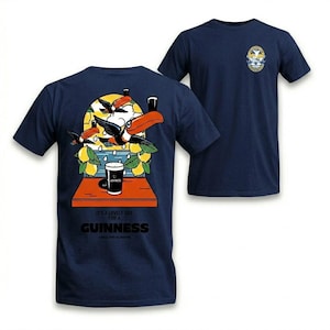 Puede incluir: Camiseta azul marino con un dise&ntilde;o colorido de tucanes, limones y una pinta de Guinness. La parte trasera de la camiseta tiene la frase "It's a lovely day for a Guinness". Un peque&ntilde;o emblema est&aacute; en la parte delantera.