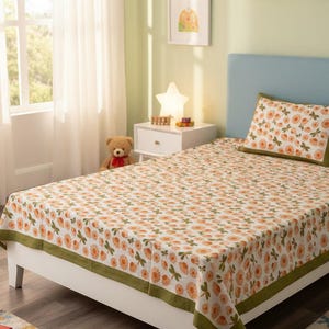 May include: A white bed sheet and matching pillowcase featuring a repeating pattern of orange flowers and green dragonflies. The bedding set includes a solid olive green border trim along the edges of the sheet and the pillowcase, providing a clean finish.
