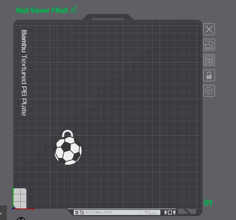 May include: A digital interface showing a Bambu Textured PEI Plate with a grid pattern. A small, white and black soccer ball charm with a silver loop is positioned on the grid. The text Nail Saver FBall is visible at the top left corner.