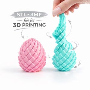 Puede incluir: Dos objetos impresos en 3D, uno rosa y otro turquesa, se muestran sobre un fondo blanco. Los objetos tienen forma de huevo y están compuestos por segmentos en forma de diamante. El objeto turquesa se está retorciendo. Texto: "STL 3MF file for 3D PRINTING".