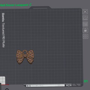 May include: A brown bow-shaped object with a pink leopard print pattern displayed on a digital grid interface labeled Nail Saver Leopard and Bambu Textured PEI Plate. The interface includes various icons and text indicating material settings.