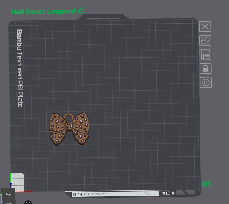 May include: A brown bow-shaped object with a pink leopard print pattern displayed on a digital grid interface labeled Nail Saver Leopard and Bambu Textured PEI Plate. The interface includes various icons and text indicating material settings.