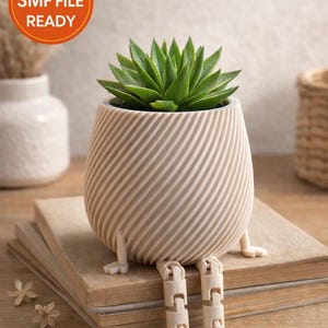 May include: A set of three ceramic mugs with a speckled, matte finish. The mugs are in shades of cream, light gray, and dark gray. Each mug has a simple, minimalist design, perfect for coffee or tea.