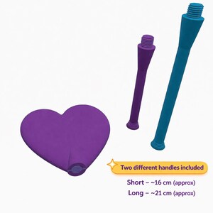 May include: A purple heart-shaped object with a threaded base, accompanied by two handles: a short purple one and a long teal one. The short handle is approximately 6.3 inches, and the long handle is approximately 8.3 inches. Text on the image says "Two different handles included."