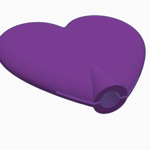May include: A solid purple heart-shaped object with a threaded opening. The heart is smooth and three-dimensional, with a slightly angled perspective. The opening has a circular shape with internal grooves.