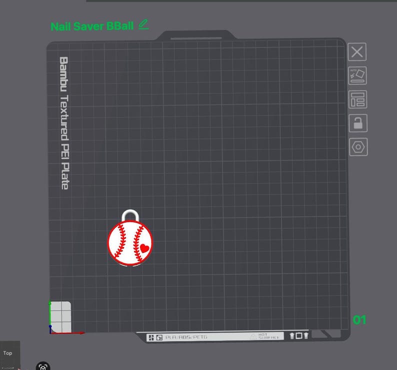 May include: A digital interface showing a Bambu Textured PEI Plate with a grid layout. A white baseball graphic with red stitching and a small red heart is positioned on the plate. The text Nail Saver BBall is visible at the top left corner.