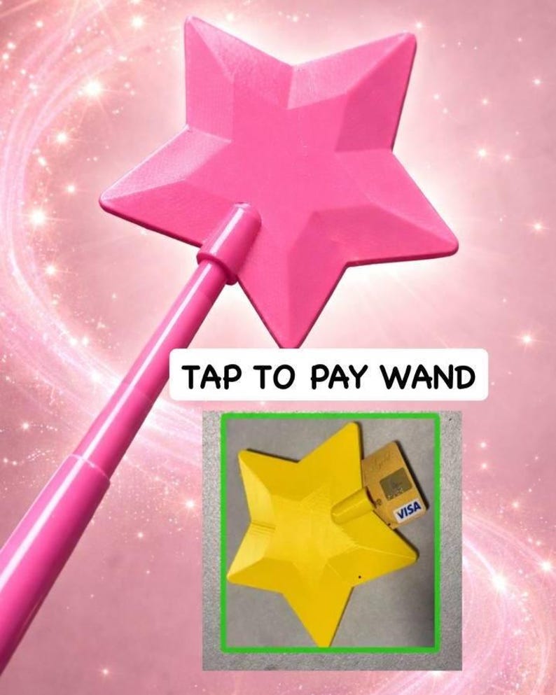 May include: A pink star-shaped wand with the text "TAP TO PAY WAND". The wand has a handle and a star-shaped head. A yellow star-shaped object with a credit card is also shown.