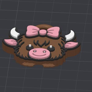 May include: A 3D-printed cow-shaped object with a brown body, pink bow, and pink ears. The cow has white horns, black eyes, and a pink nose with a smiling mouth. The object is designed with a dark outline.