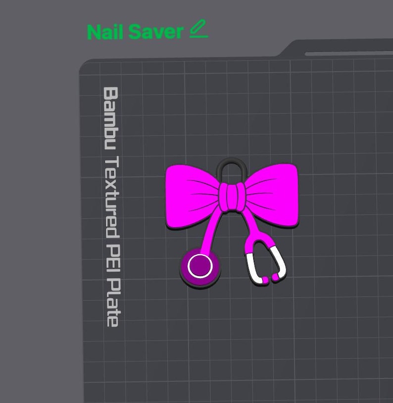 May include: A bright pink bow icon with a stethoscope attachment, featuring a dark purple chest piece and white earpieces. The design is displayed on a dark gray grid background with the text Nail Saver and Bambu Textured PEI Plate.