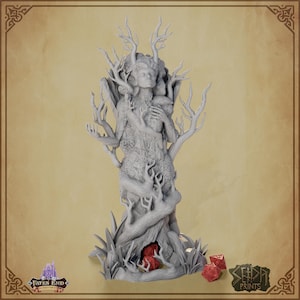 May include: A gray, detailed fantasy figurine of a woman intertwined with a tree, featuring branches and antlers. The sculpture has a serene expression and is surrounded by red dice and grass.