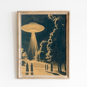 May include: Framed art print depicting a vintage-style scene of a UFO hovering over a forest at night. The artwork features a gold and navy color palette, with figures standing on a path illuminated by the spacecraft's light.