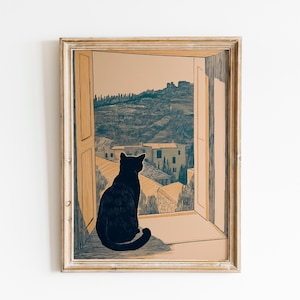 May include: A framed art print depicting a black cat looking out of a window at a European village. The artwork has a vintage aesthetic, with a neutral colour scheme of beige, brown, and blue-grey. The cat is the central element.