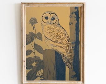 May include: Framed art print featuring a detailed illustration of an owl perched on a wooden post. The owl is rendered in shades of brown and tan against a golden background. A blue tree and floral elements add contrast. The artwork is enclosed in a light-colored wooden frame.