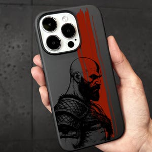 a hand holding a black and red iphone case