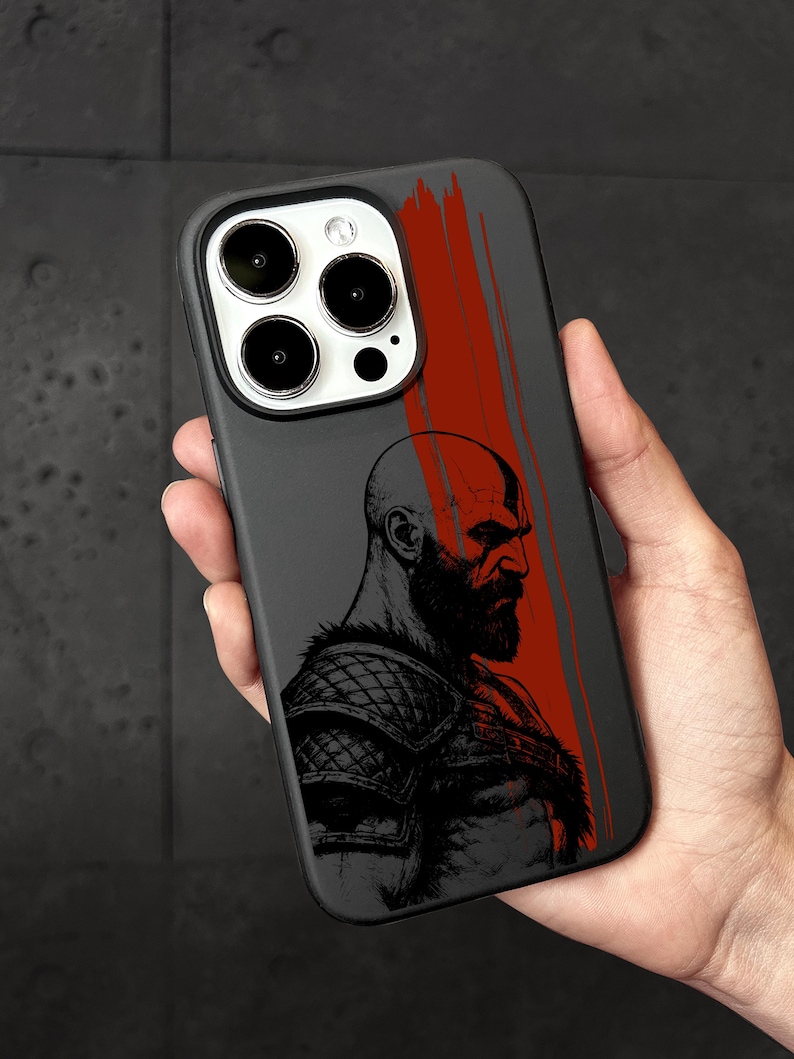 a hand holding a black and red iphone case