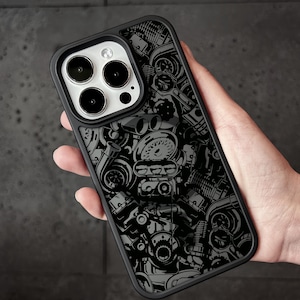 May include: Black phone case with a detailed engine parts design. The case features a black border and a gray and black graphic of various engine components, including turbochargers and gauges. The case is designed to fit a smartphone.