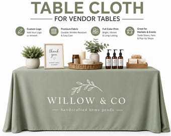 May include: A sage green custom table cloth featuring the white text WILLOW & CO handcrafted home goods with a leaf graphic. The display includes a thank you sign, a woven basket with candles, a potted plant, three pump bottles, and soap bars.