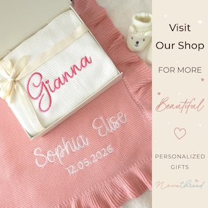 May include: A white knitted blanket with the name Gianna embroidered in pink, placed inside a gift box with a cream ribbon. Beside it lies a pink knitted blanket embroidered with the name Sophia Elise and the date 12.05.2026, plus white baby booties.