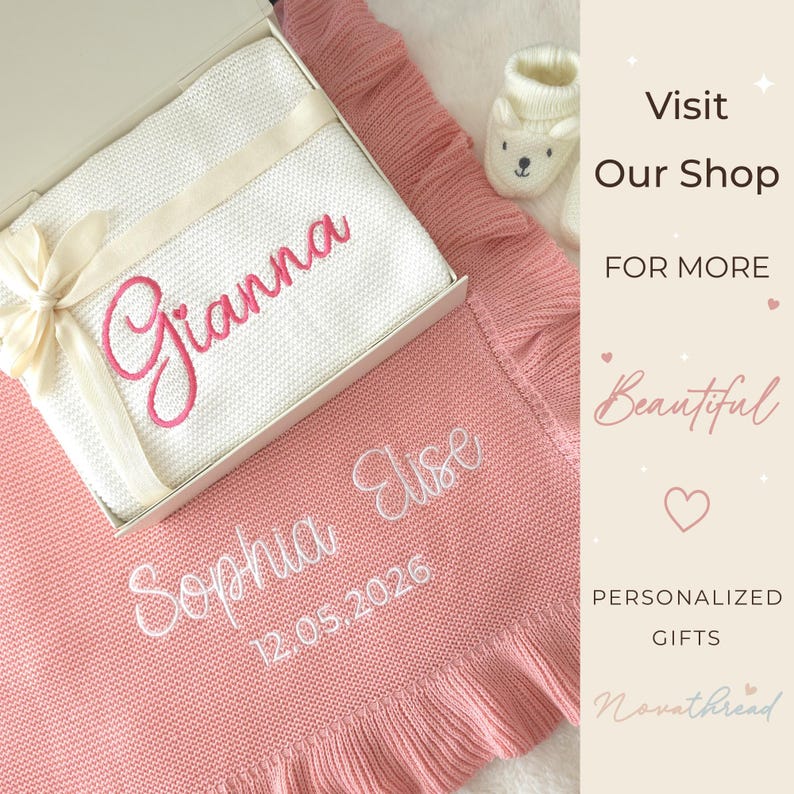 May include: A white knitted blanket with the name Gianna embroidered in pink, placed inside a gift box with a cream ribbon. Beside it lies a pink knitted blanket embroidered with the name Sophia Elise and the date 12.05.2026, plus white baby booties.