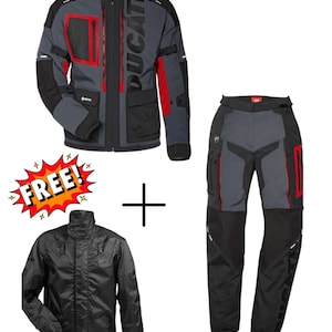 May include: A grey and black motorcycle jacket and trousers set with red detailing. The jacket features the word "DUCATI". A black rain jacket is also included. The set is designed for motorcycle riding.
