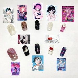 May include: A collection of rectangular anime-style character stickers and individual press-on nails. The stickers feature various illustrated figures in vibrant colors, while the nails display diverse textures, including metallic, glossy black, white, and pink finishes with 3D embellishments.
