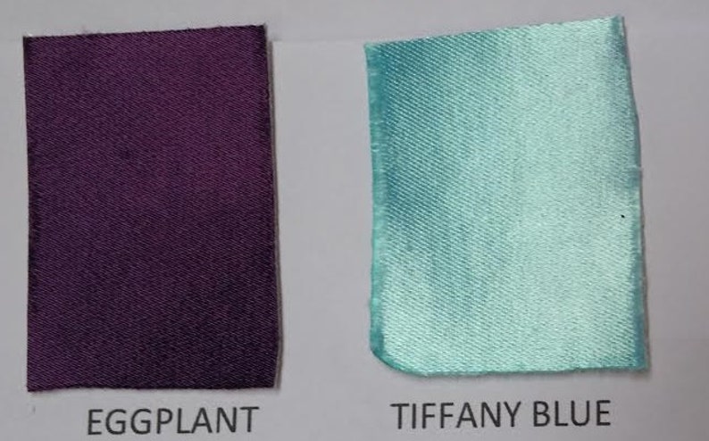 May include: Two fabric swatches, one eggplant purple and one Tiffany blue.