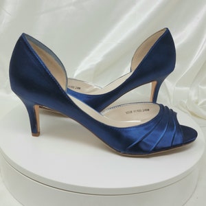 a pair of medium height navy blue satin peep toe bridal shoes