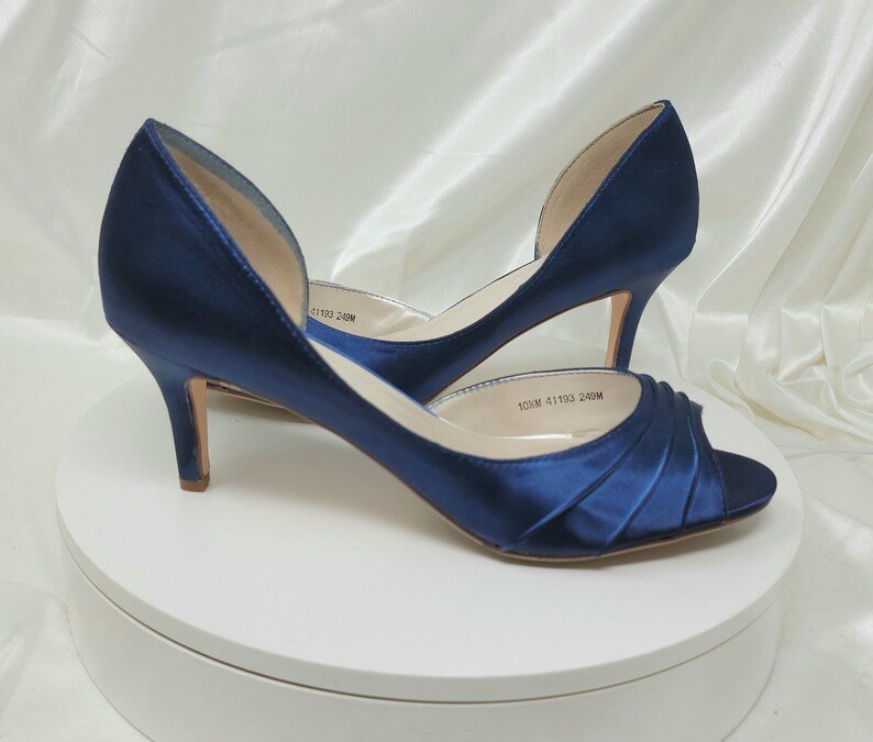 a pair of medium height navy blue satin peep toe bridal shoes