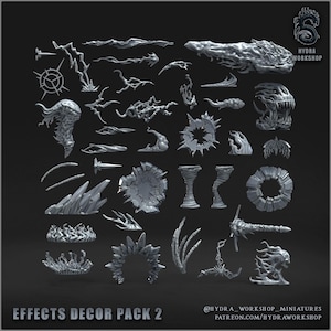 May include: A collection of grey miniature gaming effect pieces including lightning bolts, magical energy bursts, swirling smoke, jagged crystal formations, and spectral creature heads. The text "EFFECTS DECOR PACK 2" and "HYDRA WORKSHOP" are visible.