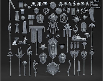May include: A selection of grey Anubis-themed miniature decor pieces, including statues, weapons, and shields. The set features various Egyptian-inspired designs, such as an Anubis statue, scarabs, and hieroglyphic elements. The text "ANUBIAN DECOR PACK" is at the bottom.